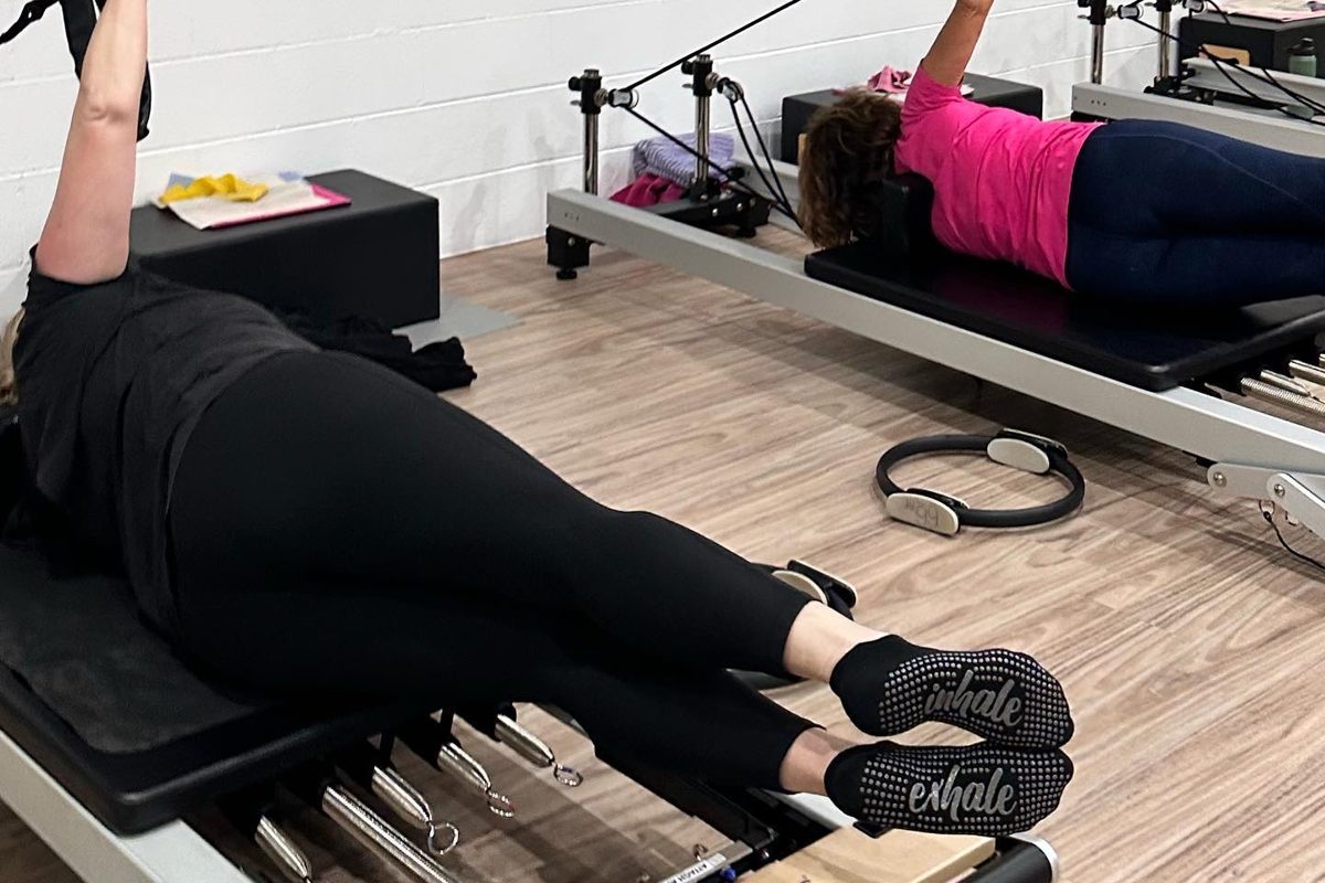 Clients doing leg work in the straps on the reformers at Pilates Rockhampton